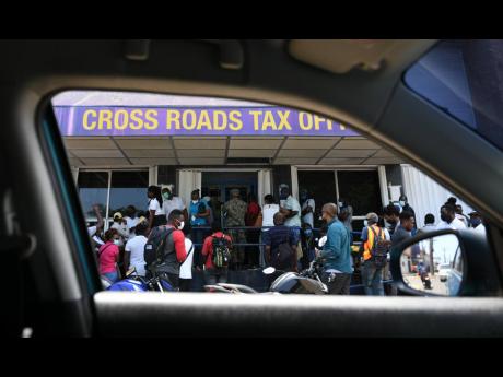 Credit: File People are seen waiting at the tax office in Cross Roads.