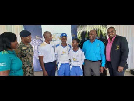 Stakeholders in the Kingston Wharves Under-15 Cricket Competition share a happy moment prior to the start of the competition – (from left)  Simone Murdock – corporate and client experience manager at Kingston Wharves, Captain Marlon Saunders of the Jam