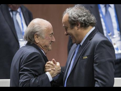 Credit: AP Sepp Blatter (left) and Michel Platini, (right).
