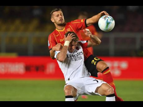  Lecce’s Ylber Ramadani (20) and AC Milan’s Santiago Gimenez battle for the ball during the Serie A match between US Lecce and AC Milan at the Via del Mare Stadium in Lecce, Italy yesterday. 