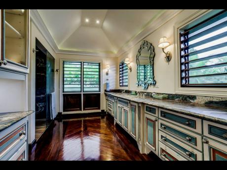 Part of the deluxe, principal bathroom, with a soaking tub, and his and her (indoor-outdoor) showers.