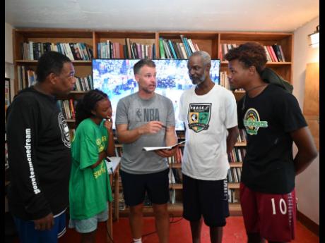 Credit: Ashley Anguin
From left: Jamaican referee Khurt Stewart, 15-year-old Manchester High School student Parys Francis-Taylor, NBA referee, Mark Lindsay, another local referee Michael Kirlew, and referee in training Wayne Lawrence have a conversation during a referee clinic
