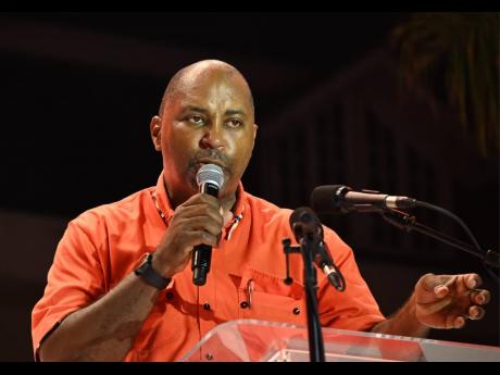 Credit: Ashley Anguin The People's National Party's Julian Robinson addressing a PNP mass rally in Sam Sharpe Square in St James on August 31.
