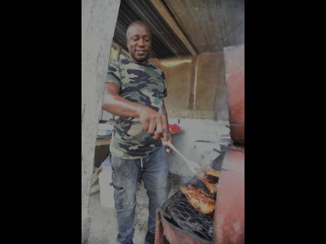 Markland James, a chef and contractor, prepares food at a function in Ramble, St Thomas Western, recently.