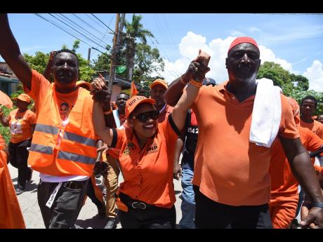Dr Miranda Wellington (centre) being escorted through the streets of Black River by supporters after her nomination in August.