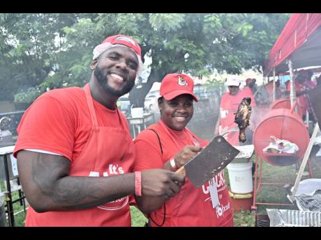 April Taylor, the 2025 PAN champion, and her assistant Craig Townsend, posing proudly with the winning chicken preparation at the competition held at Jamaica College on Old Hope Road in Kingston on Sunday.