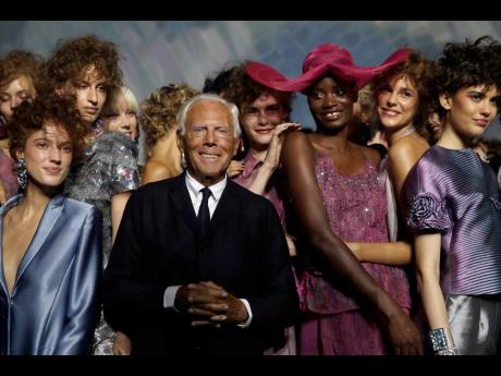 Designer Giorgio Armani (centre), poses with models at the end of his women's 2019 Spring-Summer collection, unveiled during the Fashion Week in Milan, Italy, Sunday, September 23, 2018.