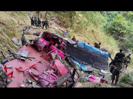 Credit: Prasanna Pathmasiri Soldiers and rescue workers stand by the debris of a passenger bus after it plunged into a precipice in Wellawaya, Sri Lanka, Friday, September 5, 2025. (AP Photo/Prasanna Pathmasiri)