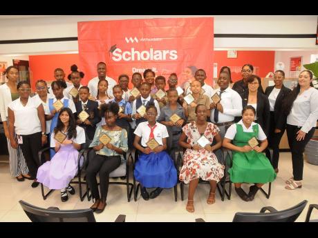 VM Scholarship recipients from the county of Middlesex share a photo opportunity with members of the VM team led by Kaydian Sinclair (second row, right), manager, sales and services at the VMBS Mandeville branch. They participated in an awards ceremony he