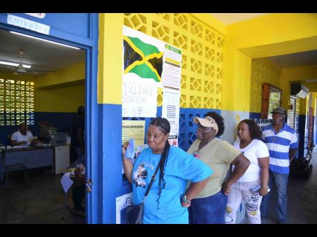People are seen waiting in line to cast their votes at Jack’s River Primary School polling station in St Mary Western constituency on September 3. 