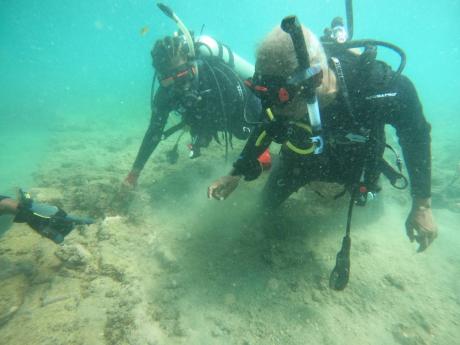 Credit: Manager of the Heritage Preservation and Planning Unit in the Archaeology Division at the Jamaica National Heritage Trust (JNHT), Jasinth Simpson (left), and chief technical director of archaeology at the JNHT, Selvenious Walters, surveying remains of a bu