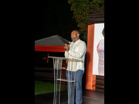 Steven Whittingham, newly minted chief executive officer of the GraceKennedy Financial Group, reads the citation for Grace Burnett’s 25 years of service to GraceKennedy.