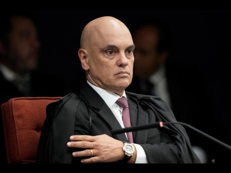 Supreme Court Justice Alexandre de Moraes attends the verdict and sentencing phase of a trial for those charged in an alleged coup plot to keep Brazil’s former President Jair Bolsonaro in office after his 2022 election defeat, in Brasilia, Brazil, Thursd