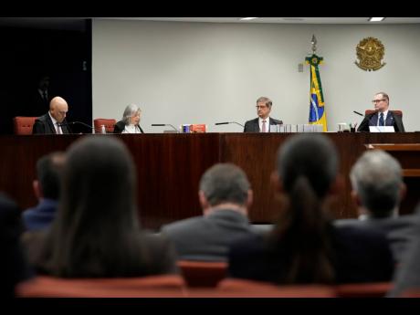 Justices of the Brazilian Supreme Court meet for the verdict and sentencing phase of a trial for those charged in an alleged coup plot to keep Brazil’s former President Jair Bolsonaro in office after his 2022 election defeat, in Brasilia, Brazil, Thursda