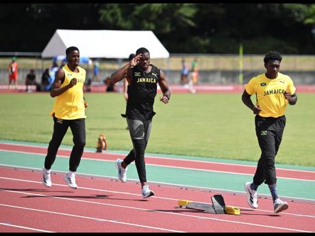 From left: Bovel McPherson, Orlando Bennett, and Antonio Watson warm up for training at the Athletic Stadium at the Oi Central Seaside Park Sports Forest in Tokyo, Japan, on Thursday.
