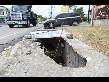 Open drains in the sidewalk along the Paul Bogle Highway in Morant Bay, St Thomas.