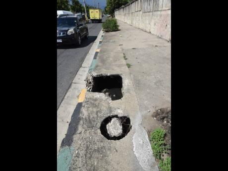 Holes in another section of the sidewalk along Slipe Pen Road.