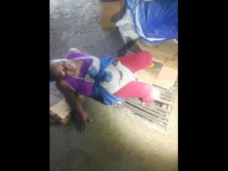 
Dorey McPherson awaiting the arrival of firefighters to free her trapped leg after several failed efforts by passers-by who rushed to her aid.