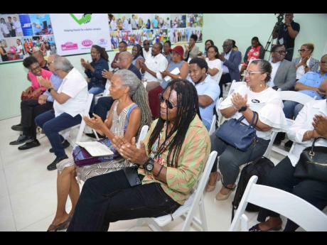 Invited guests applaud at the recent Lasco Chin Foundation press conference to unveil its Cultural Entrepreneurship Programme.