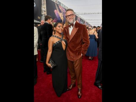 Quinta Brunson (left) and Seth Rogen walk the red carpet at the 77th Emmy Awards, Brunson in Louis Vuitton and Rogen in custom Etro.