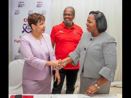  CIBC Caribbean’s Head of Country Annique Dawkins (left) greets Roshane Reid Koomson, executive director of the Jamaica Cancer Society (JCS) at the launch of the 14th annual CIBC Caribbean Walk for the Cure. Looking on is Alfred ‘Frano’ Francis, ma