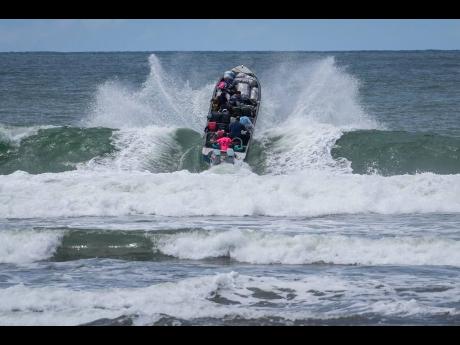 Venezuelan migrants depart Jaque on Panama’s Pacific coast en route to Jurado, Colombia, as they return home after failing to enter the United States on Friday, September 19. 