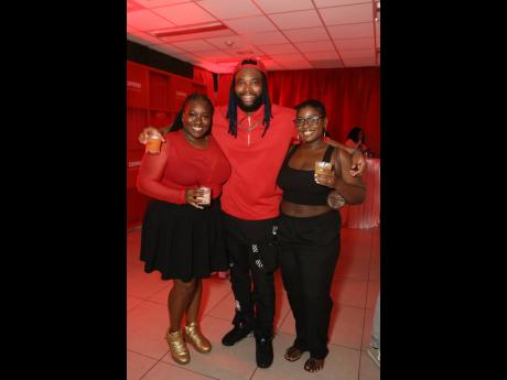 Radio personality and disc jockey Brush 1 the Road Marshall, decked out in red and black, is flanked by creative project and tour manager Lauren ‘Lo’ Watkis (left) and Cheraine Marshall, music executive of the Tastemaker Agency.