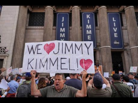 Credit: AP Oscar Villanueva holds a sign outside the El Capitan Entertainment Centre in Los Angeles last Thursday, where the late-night show Jimmy Kimmel Live! is staged.