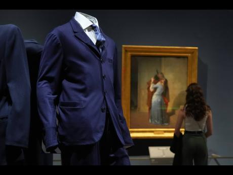 Credit: AP Giorgio Armani’s creations set against the painting ‘The Kiss’ by Francesco Hayez.
