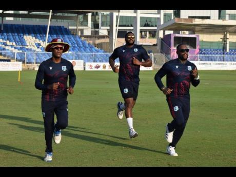 West Indies captain Akeal Hosein (left) leads players during a training session yesterday.