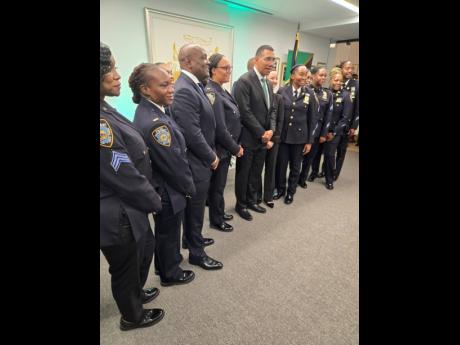 Prime Minister Dr Andrew Holness with Jamaican members of the New York Police Department during the reception at the Jamaican Consulate in New York. 
