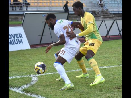 Harbour View FC’s defender Keanu Barrett (left) shields the ball from Treasure Beach FC’s Chandol Anderson during their Jamaica Premier League match at the Montego Bay Sports Complex yesterday.