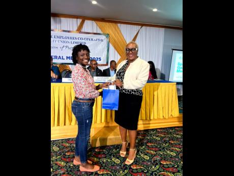 Morganne Brown, daughter of Nickeisha Graham, earned a place at Campion College and received her award from Ms. Diana Facey, treasurer of the IECCU Board of Directors.