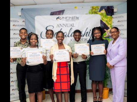  Camille Campbell Drummond, chief executive officer, Infiniti Co-operative Credit Union Jamaica Limited, poses alongside a group of top achievers in the recent PEP examinations. The awards were presented during a ceremony held on August 22 at the Infiniti 