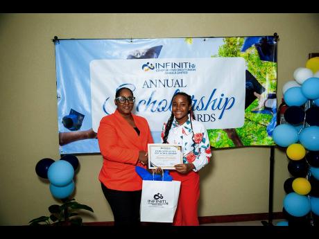 Rhamona Mohan Samuels, Acting Chief Operating Officer, Infiniti Co-operative Credit Union Jamaica Limited, presents a recipient with the Enid Gonsalves PEP Scholarship during a special presentation at the Infiniti Co-operative Credit Union office in Church