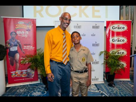 Credit: Contributed It’s a proud moment as young Michael draws close to his dad Cary Fletcher at the recently held Pocket Rocket Foundation Scholarship Awards Ceremony.