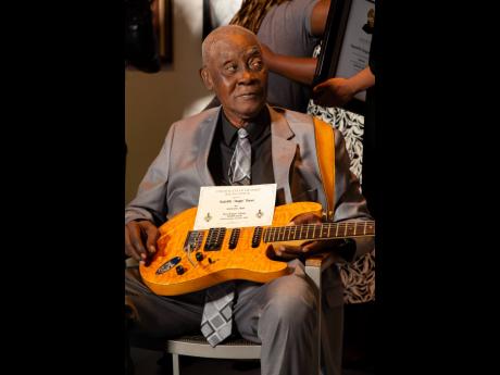 Radcliffe ‘Dougie’ Bryan with his guitar at the 2024 Grammy Certificate Ceremony, Florida, last July.
