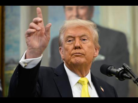 
President Donald Trump speaks during an event in the Oval Office at the White House.