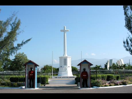 Members of the 2nd Battalion of the Jamaica Regiment stand guard outside of the cenotaph of the National Heroes Park in 2005.