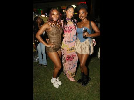  Naomi Cowan (centre), in a graffiti dress and matching thigh highs, is flanked by fellow artistes Tori Lattore and Joby Jay.