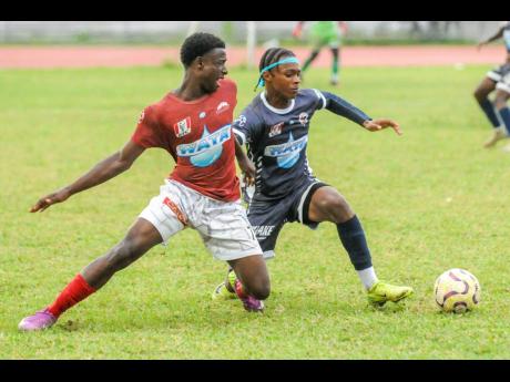 Eltham High School’s Antonio Fearon (left) finds himself going the wrong way against the dribble of Jamaica Collegee’s Devonte Allen during their ISSA/WATA Manning Cup round-of-16 clash at the Jamaica Colleege Ashenhim Stadium yesterday.