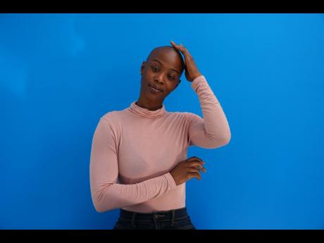 Aicha Soumaoro, a Philadelphia nurse and weekend mechanic, proudly embraces her bald look despite old-fashioned reactions from others.