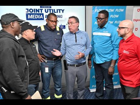 Officials of the Jamaica Public Service, Digicel, Flow, National Water Commission, and National Works Agency at a joint news conference on Hurricane Melissa on October 26, 2025. 