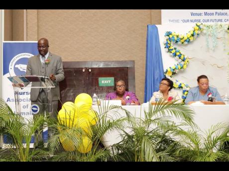 Credit: Contributed Photos Delroy Williams (left), principal of Iona High, delivers the keynote address at the Nurses Association of Jamaica’s (NAJ’s) 55th Island Conference at the Moon Palace Hotel in Ocho Rios, St Ann, recently. Listening on are (from left): Dawn Marie Richard