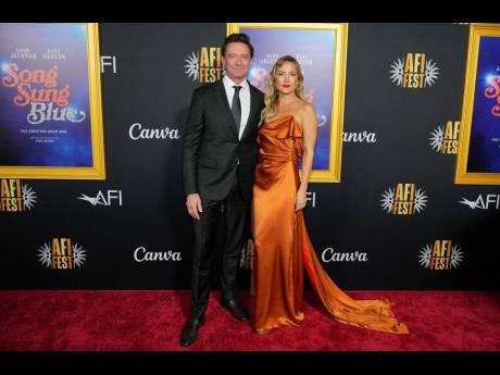 Co-stars of ‘Song Sung Blue’, Hugh Jackman and Kate Hudson, pose for the cameras at the AFI FEST premiere on Sunday.