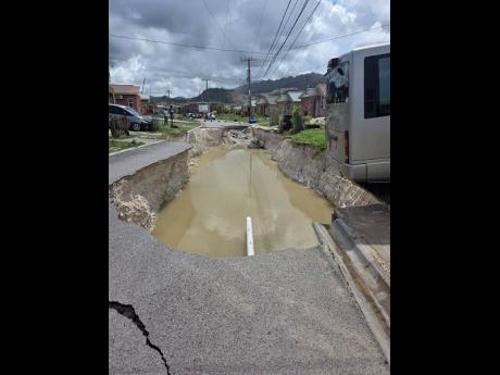Right: A damaged road in The Estuary, St James.