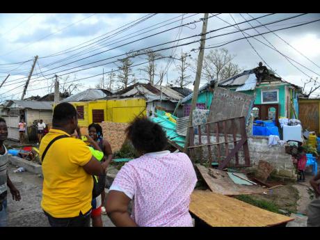 Residents of Cornwall Street, Compound in Trelawny look at the damage done to their homes after the passage of Hurricane Melissa, which swept through the island on October 28.