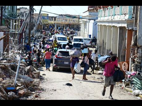 Persons in Black River, St Elizabeth following the passage of Hurricane Melissa.