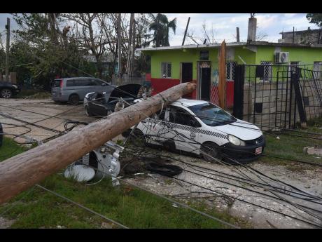 A utility pole which broke during the passage of Hurricane Melissa fell on a parked car in Salt Marsh, Trelawny.