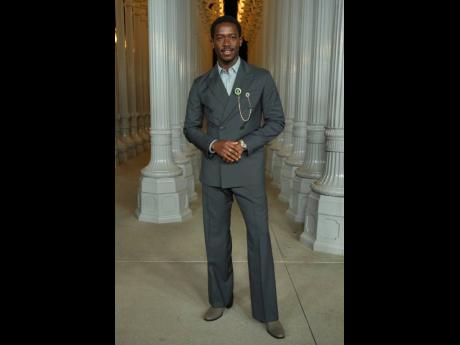 Credit: AP Damson Idris serves style in a double-breasted grey Prada suit.